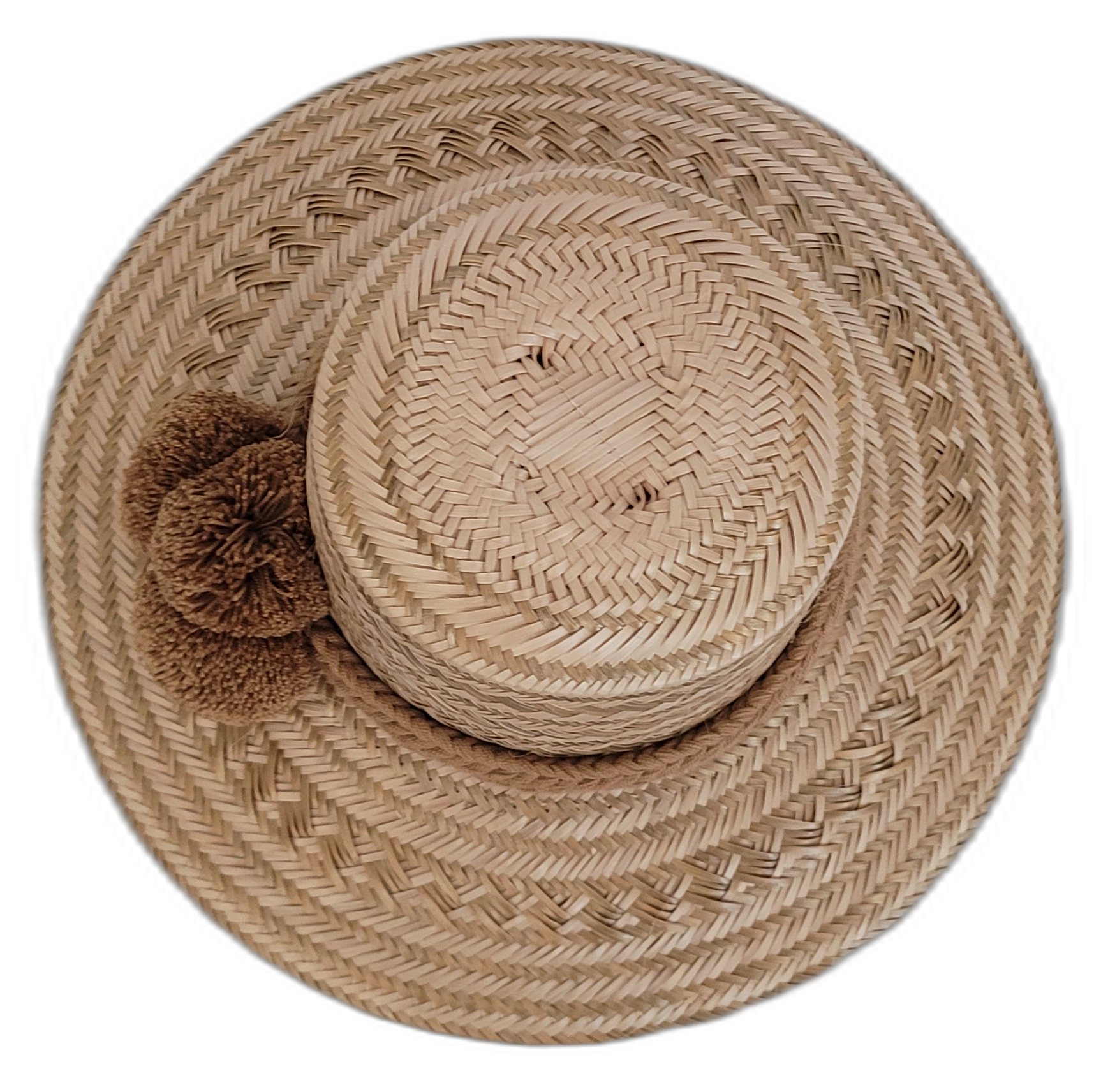 Wayuu handcrafted straw hat in natural tones with brown pompoms.

