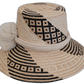 Colorful Boho straw hat, crafted from Iraca palm, featuring cream pompoms and black-beige details.


