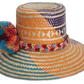 Boho hat featuring bright pompoms in red, blue, and orange