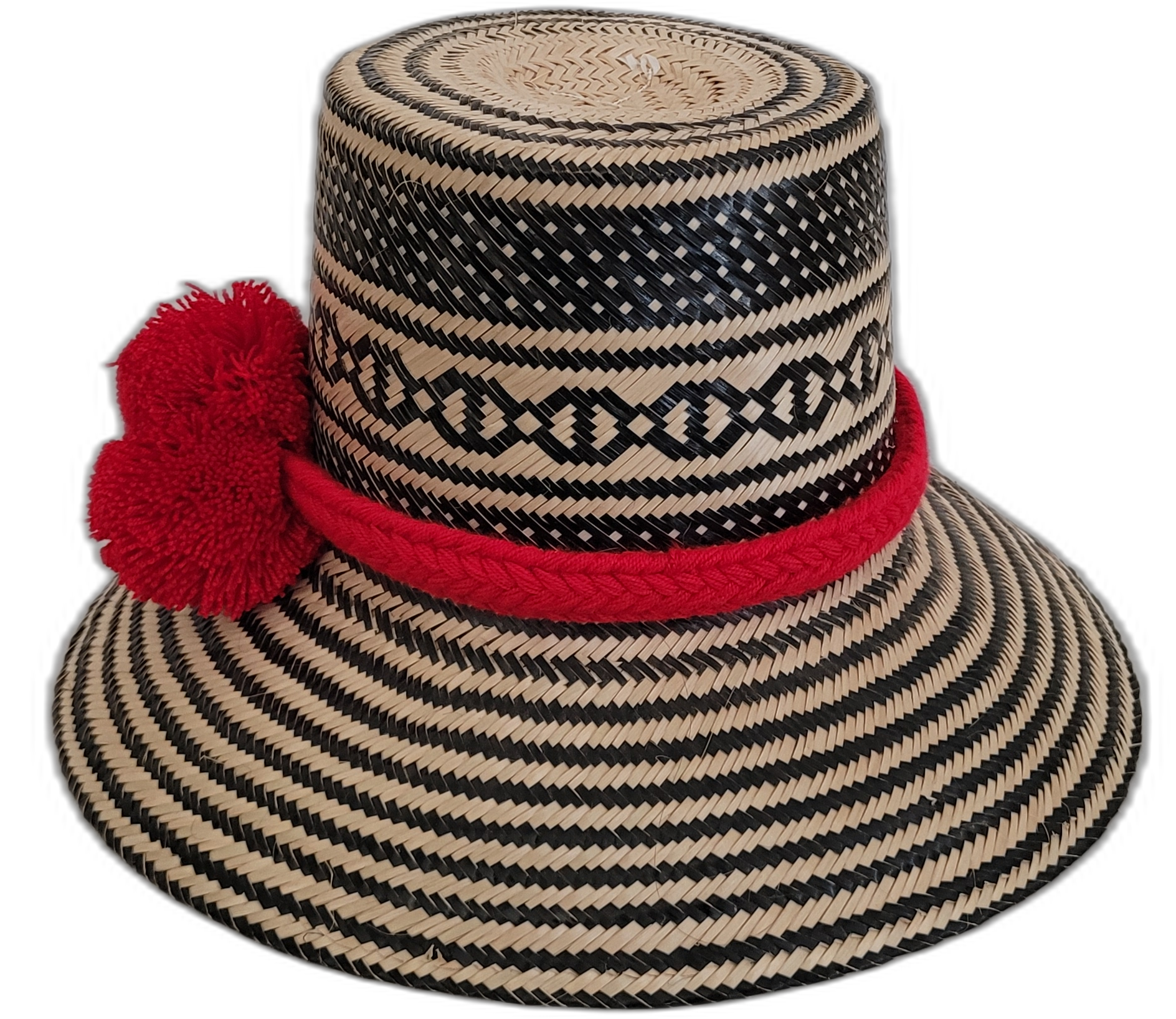 Colorful Boho straw hat, crafted from Iraca palm, featuring red pompoms and striking black-beige weave.

