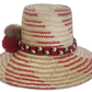 Boho Chick hat with braided band and colorful pompoms in earthy tones.Bohemian straw hat featuring red, ivory, and brown color details

