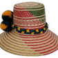 Boho chick straw hat featuring bold yellow and green pompom accents.Artisan Wayuu hat featuring geometric pattern and bright fluffy pompoms

