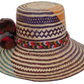 Artisan Wayuu hat with bold turquoise stripe and cultural bohemian style pompom detail.Wayuu hat with zigzag earth-tone pattern and vibrant braided crown band



