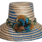 Handmade Wayuu straw hat with blue and earth-toned pompoms