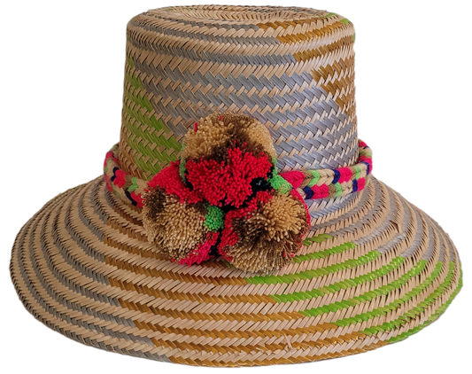 Handmade Wayuu straw hat with lavender, lime, and red pompom accents.