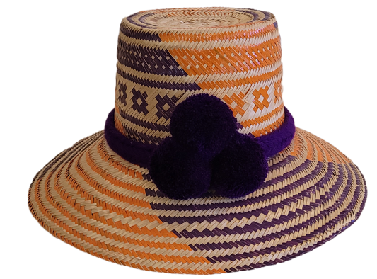 Handmade Boho straw hat in orange and purple with triple pompoms, crafted by Wayuu artisans.