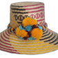 Handmade Wayuu straw hat with yellow, blue, and maroon pompoms