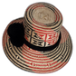 Artisan Wayuu hat in natural palm straw with black pompom detailing