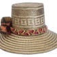 Artisan Wayuu hat with intricate weave, neutral colors, and bold pompoms
