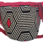Bohemian artisan Wayuu bag with bold red crochet strap and tassel ties, paired with striking black and white woven design — handmade and colorful.