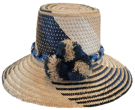"Colorful artisan Wayuu hat handcrafted from Iraca palm fibers, adorned with symbolic pompoms, showcasing adjustable styles f