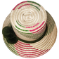 "Colorful artisan Wayuu hat with decorative pompoms, handwoven from Iraca palm, showcasing unique craftsmanship and cultural 