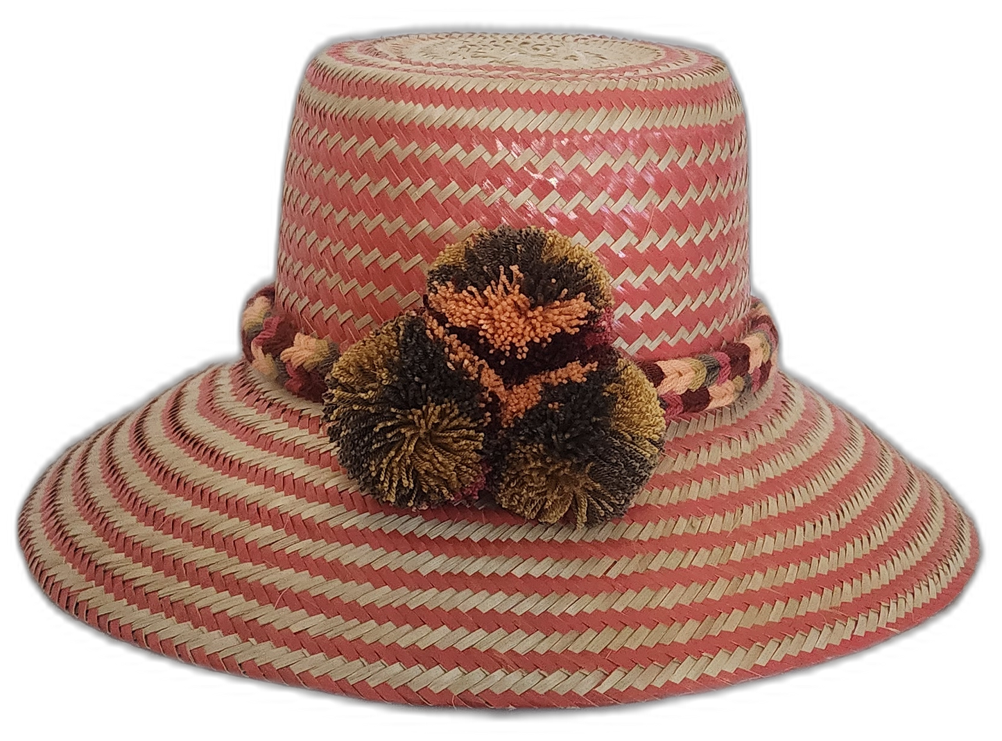 Colorful Boho Straw Hat handmade by Wayuu artisans with bold pompoms and chevron weave.Alexandra boho Wayuu hat with soft pink and beige zigzag pattern

