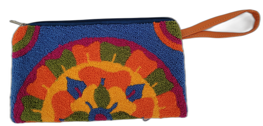 Colorful Wayuu clutch named Brynn, crafted with punch needle embroidery in orange, navy blue, golden yellow, green, and hot pink. Boho chic and fair trade.

