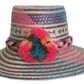 Colorful handmade Wayuu hat with pink, teal, and peach pompoms
