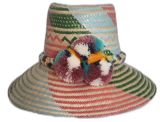 Handmade boho straw hat with vibrant pastel stripes and multicolor pompoms, crafted by Wayuu artisans.