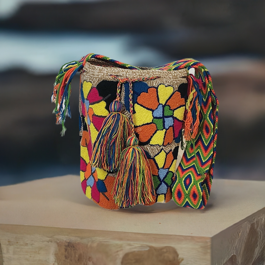 Handmade Wayuu bag with colorful floral punch-needle design and boho vibe