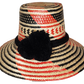 "Colorful handcrafted Artisan Wayuu hat adorned with meaningful pompoms, made from Iraca palm fibers by Wuitusu artisans."