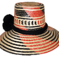 "Colorful handcrafted Artisan Wayuu hat adorned with meaningful pompoms, made from Iraca palm fibers by Wuitusu artisans."
