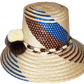 "Colorful, handcrafted Wayuu hat from Wuitusu, adorned with cultural pompoms, made from Iraca palm fibers."