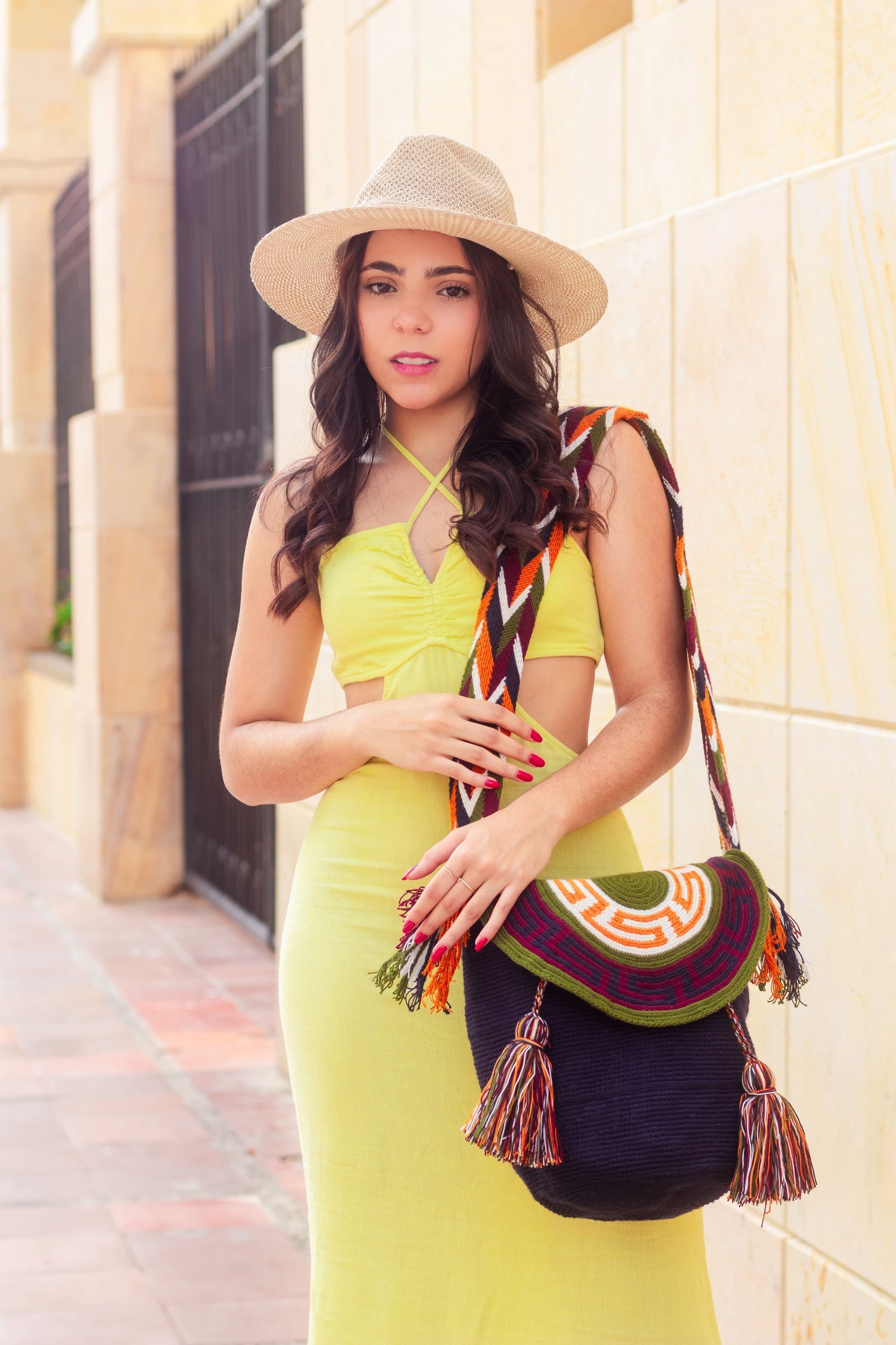 "Colorful handcrafted Wayuu mochila bag with lid, showcasing traditional crochet patterns and bohemian flair."