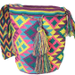 "Colorful handcrafted Wuitusu Wayuu bag with geometric patterns, featuring adjustable straps for shoulder or crossbody wear."