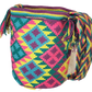 "Colorful handcrafted Wuitusu Wayuu bag with geometric patterns, featuring adjustable straps for shoulder or crossbody wear."