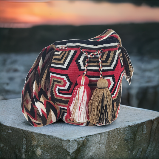Handmade colorful bohemian Wayuu crochet bag with vibrant patterns and artisan details