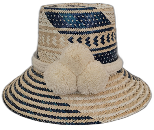 Handmade Boho Wayuu straw hat with bold pink and purple pompoms and artisan weaving