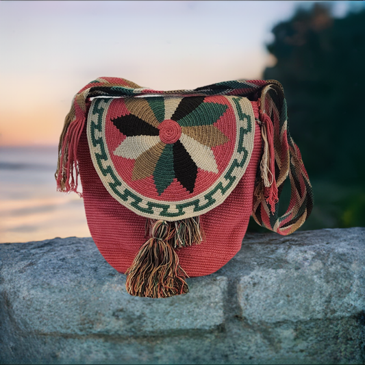 "Colorful handmade crochet bag by Wayuu artisans, featuring intricate patterns and a secure lid, ideal for various occasions.