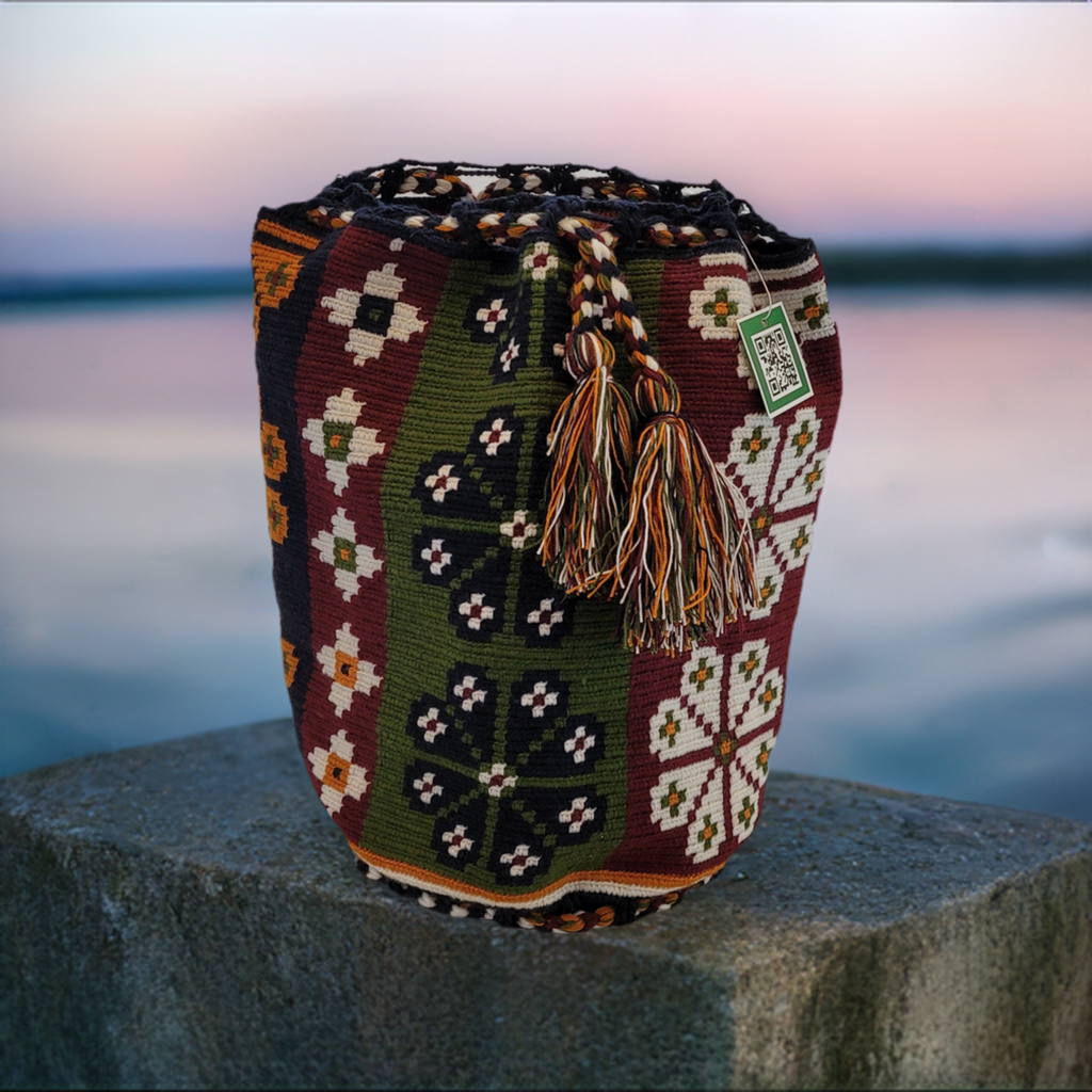 "Colorful handmade crochet crossbody bag by Wayuu women, showcasing vibrant patterns and hues, symbolizing cultural heritage.
