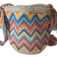 "Colorful handmade crochet crossbody bag by Wuitusu, showcasing intricate Wayuu patterns, with a flexible, long strap."