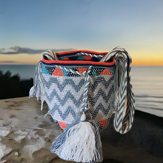 "Colorful handmade crochet Wayuu bag featuring intricate geometric patterns and a long strap, showcasing bohemian artistry an