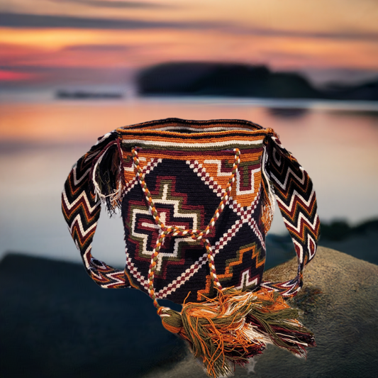 "Colorful handmade Crochet Wayuu bag with geometric designs, crafted by Wayuu artisans, perfect for versatile use."