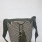 "Colorful handmade Crochet Wayuu bag with geometric motifs, crafted by indigenous artisans, perfect for versatile use."