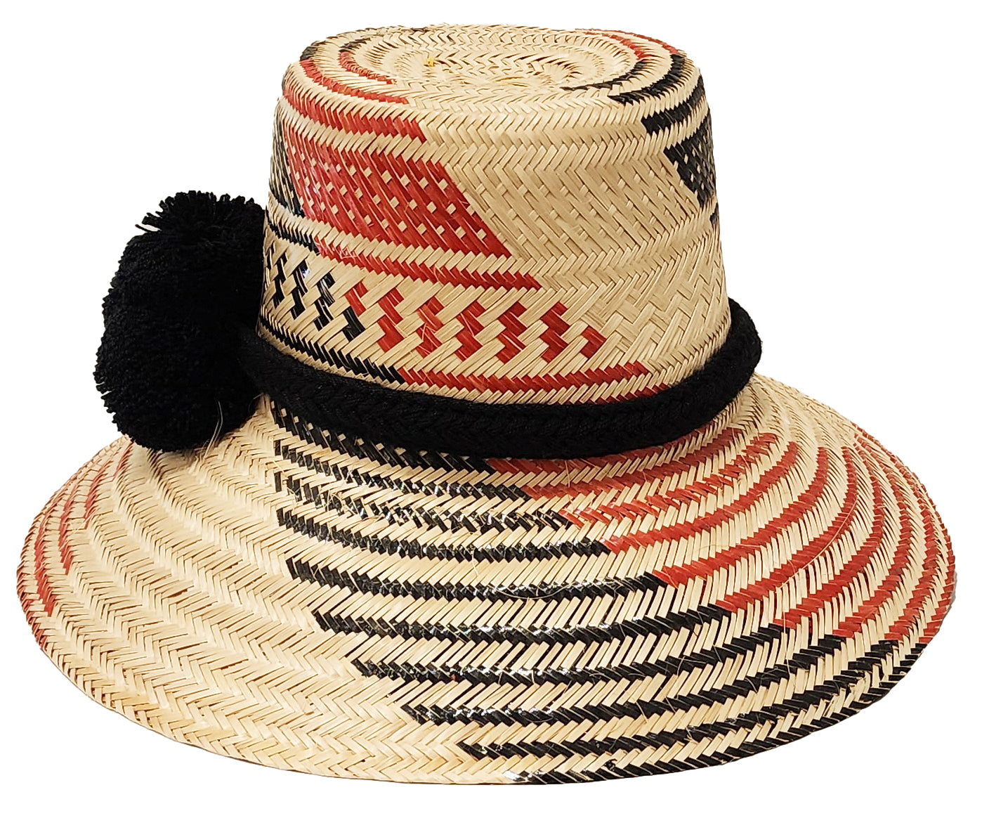 "Colorful handmade hats by Wuitusu, crafted from Iraca palm fibers by the Wayuu tribe, adorned with cultural pompoms."