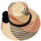 "Colorful handmade hats by Wuitusu, crafted from Iraca palm fibers by the Wayuu tribe, adorned with cultural pompoms."