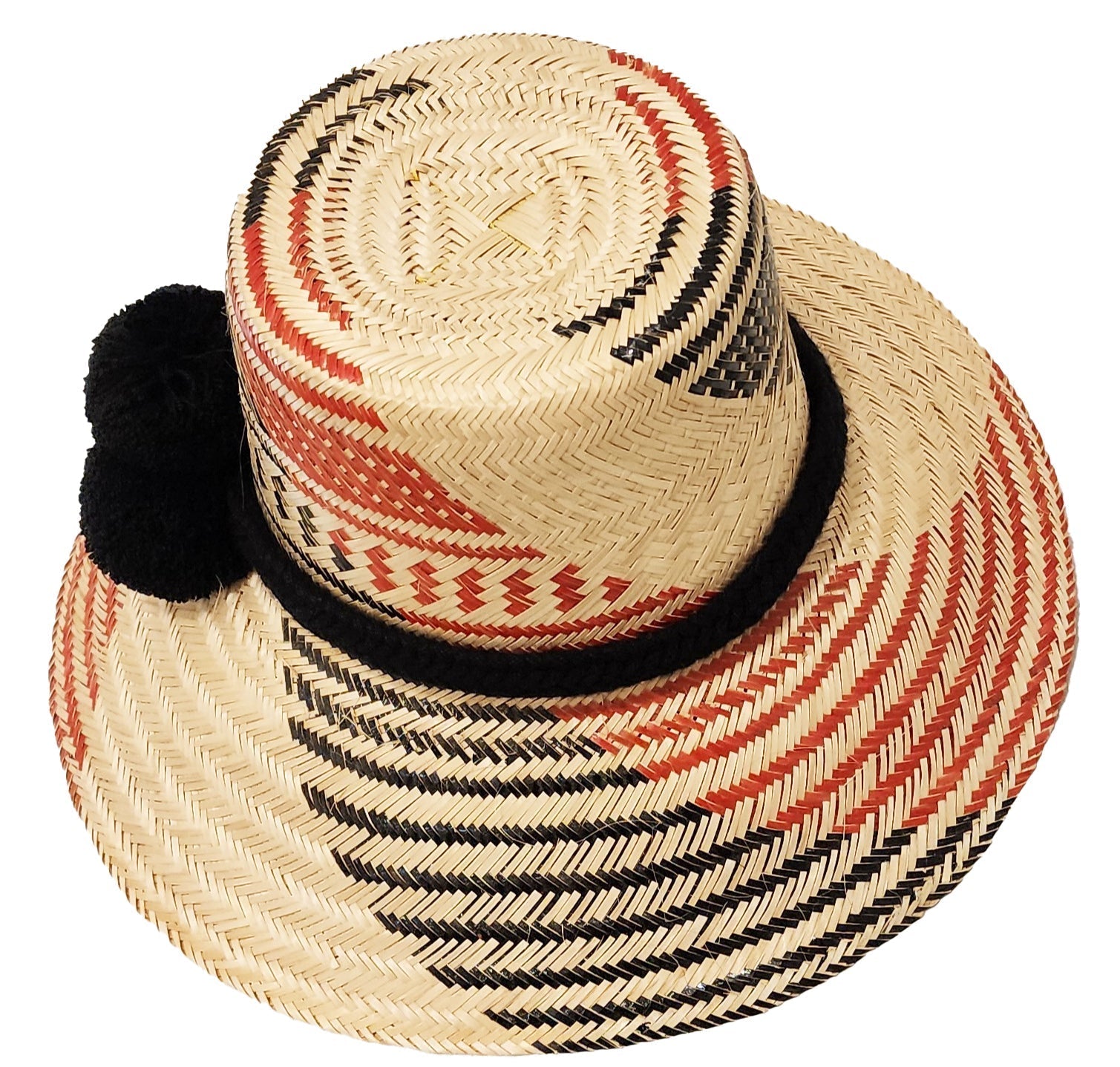 "Colorful handmade hats by Wuitusu, crafted from Iraca palm fibers by the Wayuu tribe, adorned with cultural pompoms."