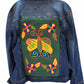 "Colorful handmade punch needle back denim jacket by Wuitusu, showcasing unique Wayuu-inspired patterns for a boho chic look.