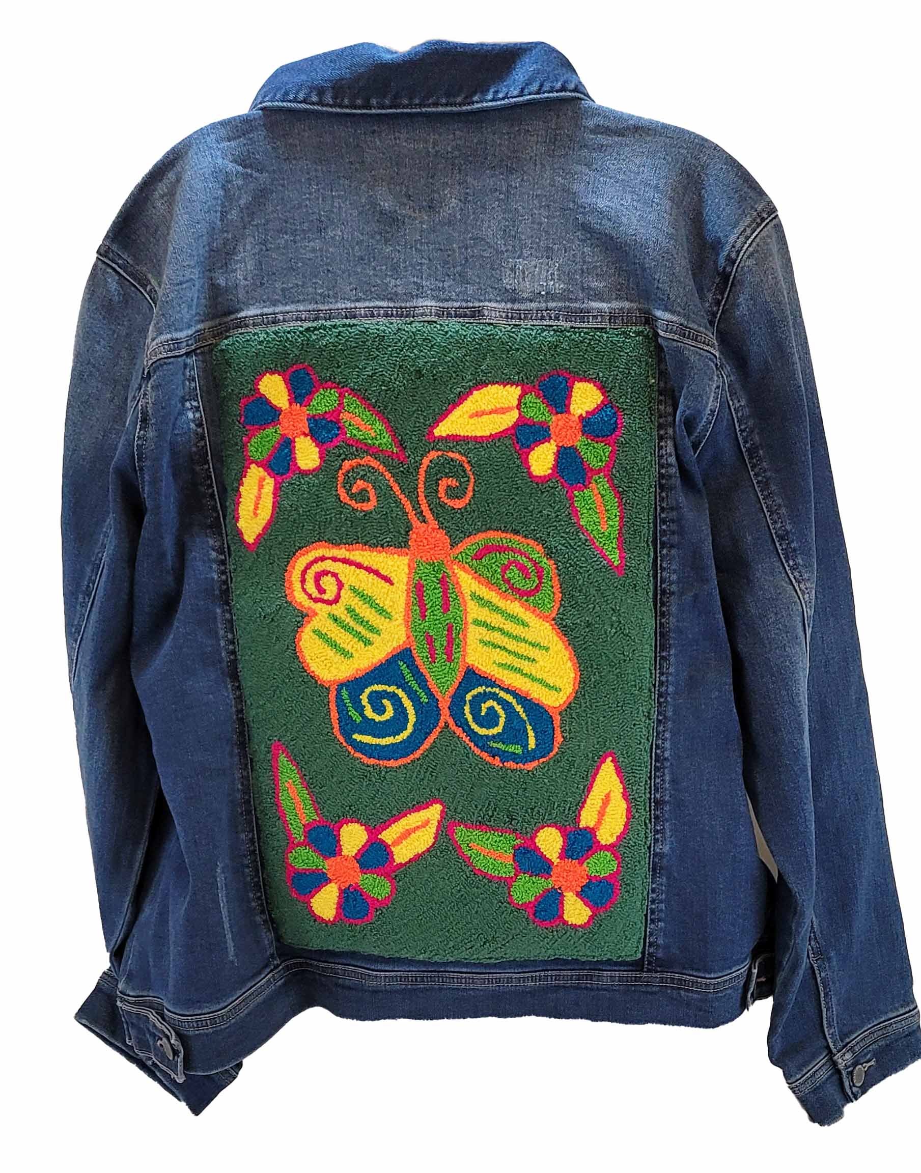 "Colorful handmade punch needle back denim jacket by Wuitusu, showcasing unique Wayuu-inspired patterns for a boho chic look.