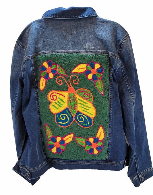 "Colorful handmade punch needle back denim jacket by Wuitusu, showcasing unique Wayuu-inspired patterns for a boho chic look.
