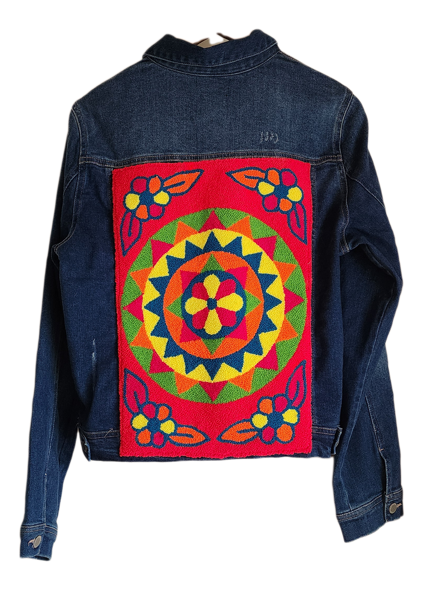 "Colorful handmade punch needle denim jacket with vibrant, artisanal embroidery on the back, showcasing unique craftsmanship.