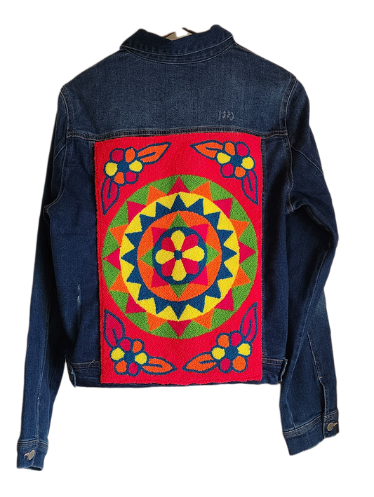 "Colorful handmade punch needle denim jacket with vibrant, artisanal embroidery on the back, showcasing unique craftsmanship.
