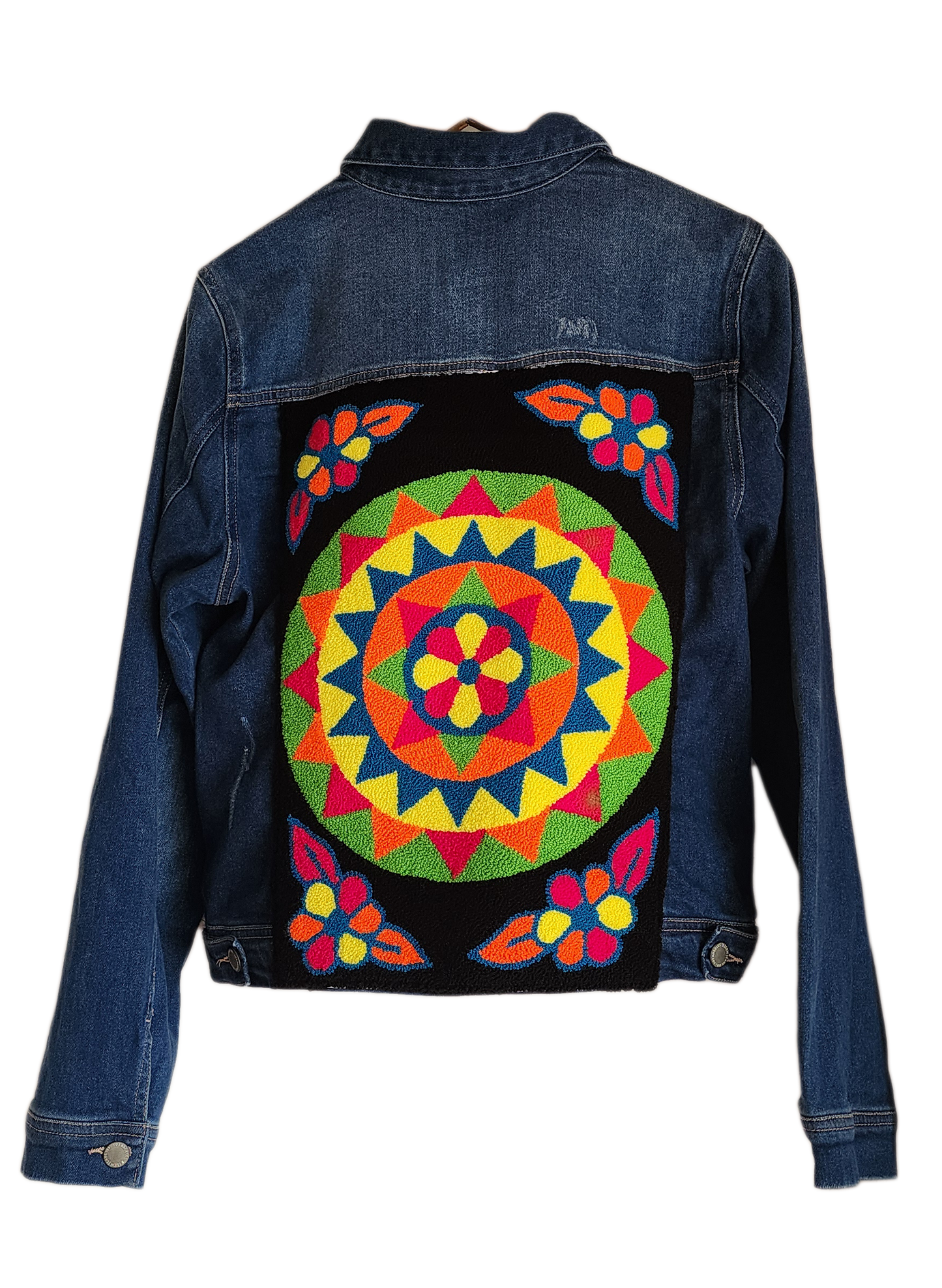 "Colorful handmade punch needle denim jacket with vibrant Wayuu-inspired embroidery, showcasing bohemian style and craftsmans