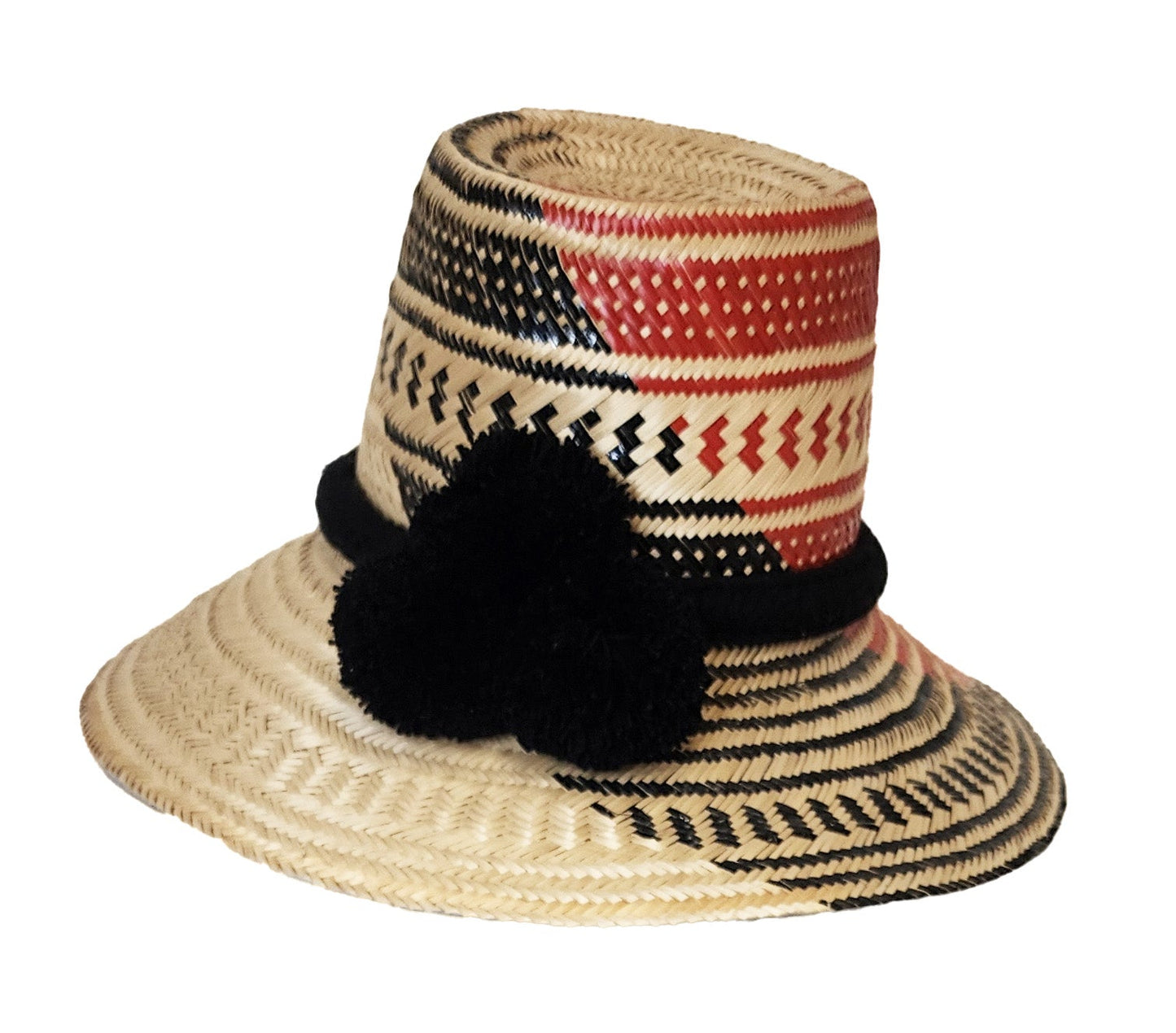 Colorful handmade straw hat by Wuitusu, woven from Iraca palm fibers, adorned with symbolic pompoms.