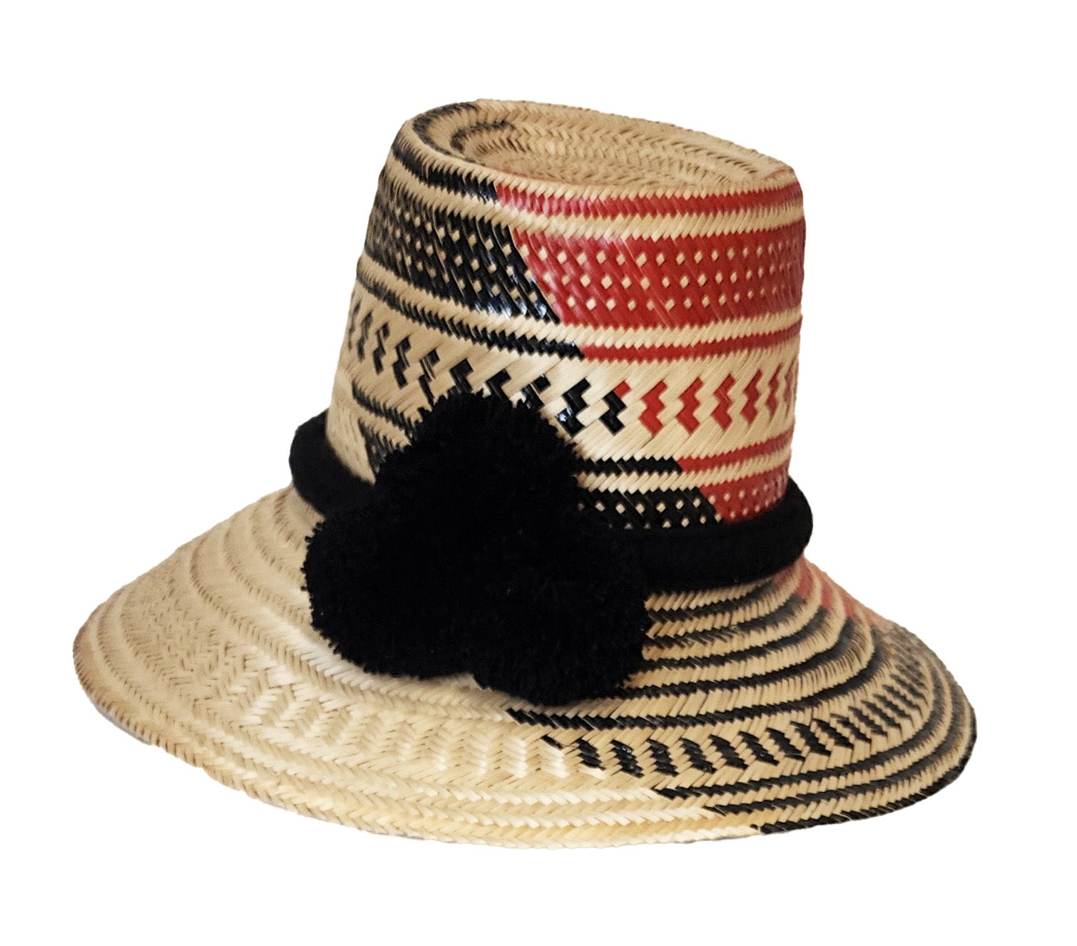 Colorful handmade straw hat by Wuitusu, woven from Iraca palm fibers, adorned with symbolic pompoms.