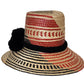 Colorful handmade straw hat by Wuitusu, woven from Iraca palm fibers, adorned with symbolic pompoms.