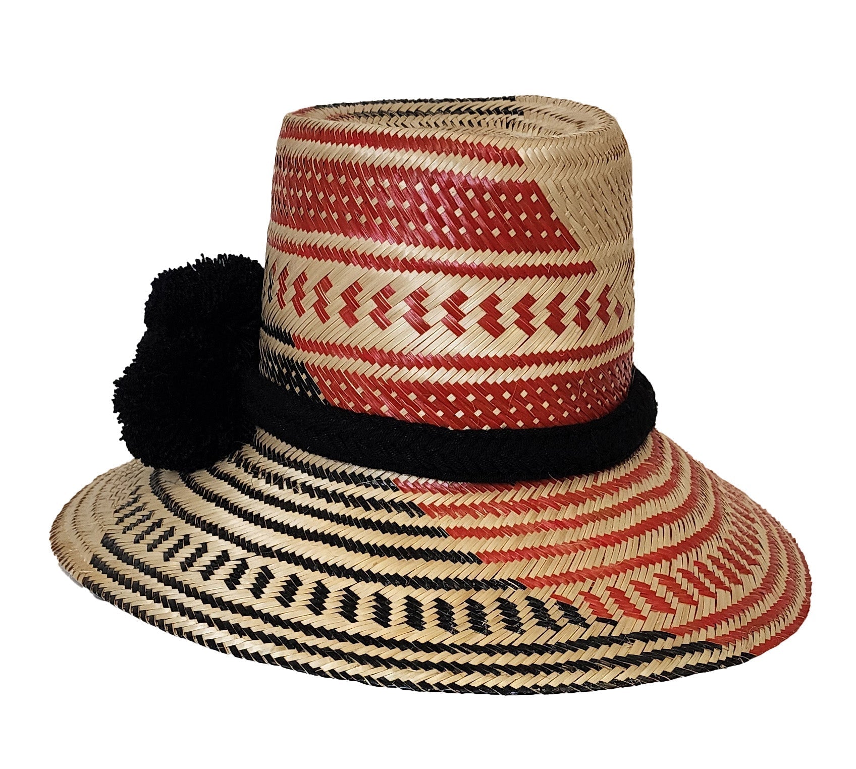 Colorful handmade straw hat by Wuitusu, woven from Iraca palm fibers, adorned with symbolic pompoms.