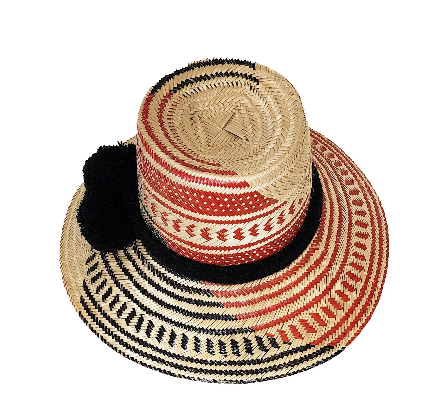 Colorful handmade straw hat by Wuitusu, woven from Iraca palm fibers, adorned with symbolic pompoms.