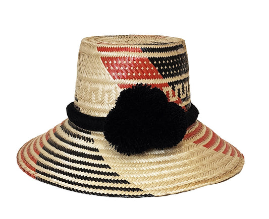 "Colorful handmade straw hats by Wuitusu, crafted by the Wayuu tribe using dyed Iraca palm fibers, with adjustable sizing and
